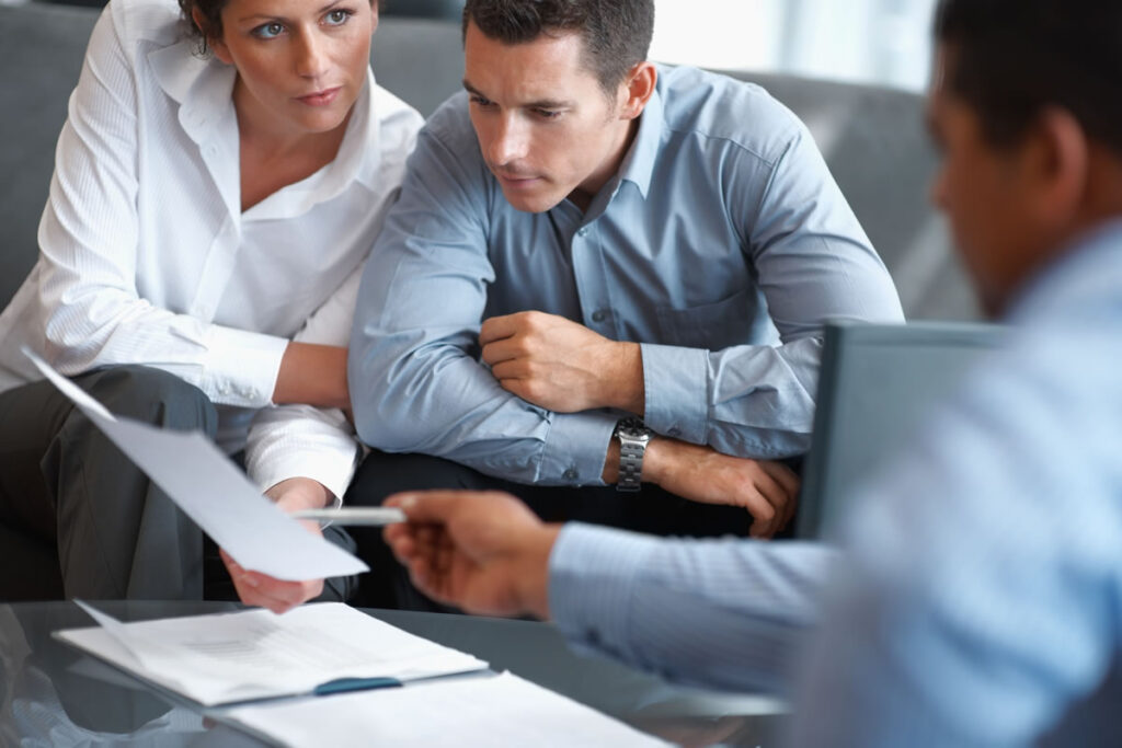 Solicitor providing legal advice to clients in meeting