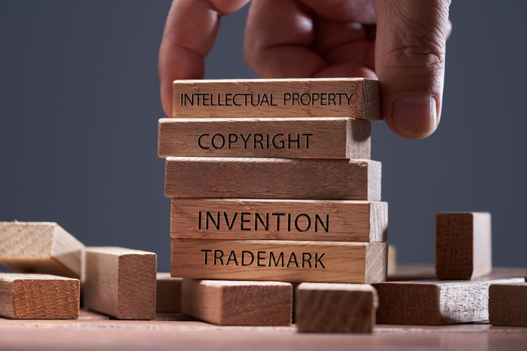 Wooden building blocks showing patents, intellectual property and trademarks