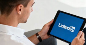 Young lawyer using Linkedin on tablet to search for legal jobs