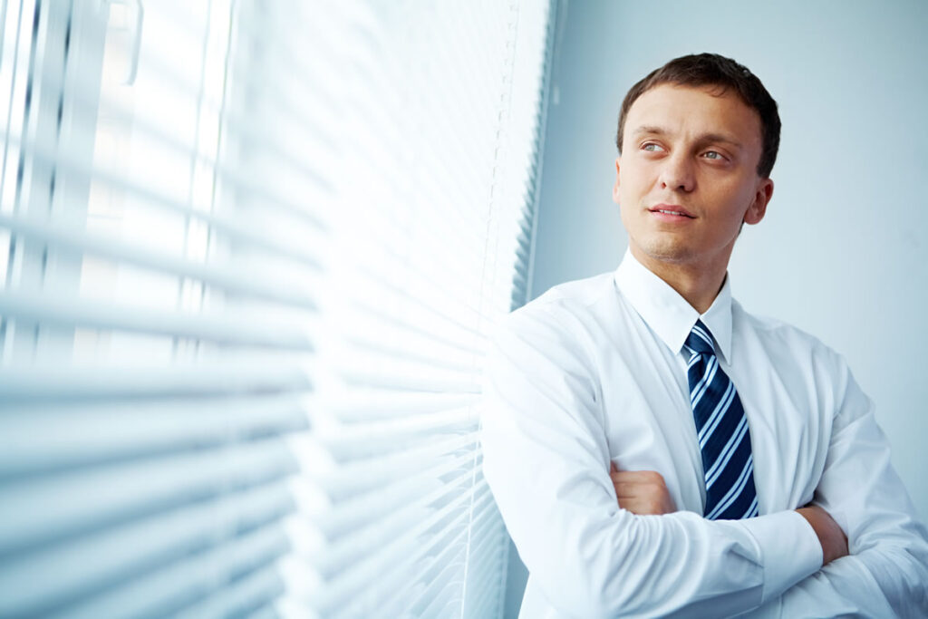 Smartly dressed male property solicitor in client meeting